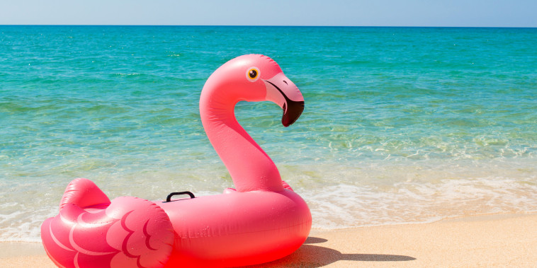 Pink inflatable Flamingo on the beach 